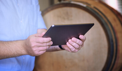 Hands, man and working with tablet in brewery, inventory check and manufacturing for beer production with tech. Factory, manager or connection with digital for research, barrel or business management