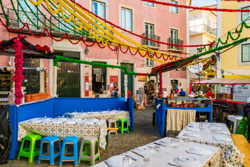 Tables of restaurant in Alfama district old town during Sardine Festival of St Anthony