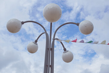 A street lamp with round shades against the sky