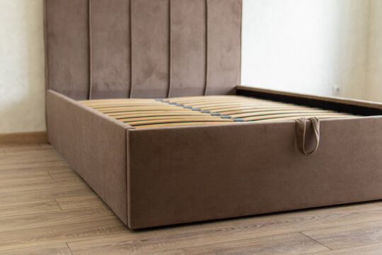 Bed with storage space. Wooden slats on the bed. Soft velour bed upholstery