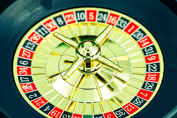 Close up shot of a spinning roulette. Presentation of a luxury casino roulette wheel with a yellow spinning fireball. Polished, elegant roulette with golden elements in Las Vegas.