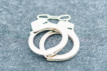 Handcuffs on an empty background, photography. Police handcuffs on dark background with copy space....