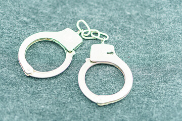 Handcuffs on an empty background, photography. Police handcuffs on dark background with copy space....