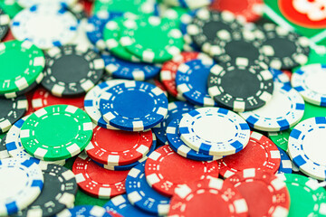 Poker Table With Poker Chips Turns In Casino. Many Poker Chips Spins on the Table in Darkness. with a winning combination in poker on a black table and chips in the background. Poker Chips on a gaming