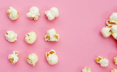 Sweet popcorn on pink background.