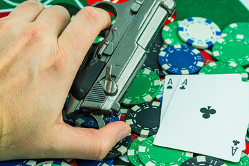 Fototapeta premium Handcuffs and a gun on a poker table - casino crime concept, underground casinos. illegal games, gambling concept. set of playing cards with dices, money and chips, on table. Casino concept, games.