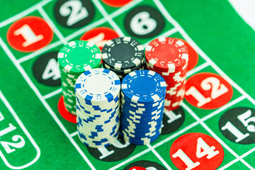 Casino background. Roulette table Chips. Casino theme. High contrast image of casino roulette, poker game, dice game, poker chips on a gaming table