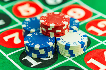 Casino background. Roulette table Chips. Casino theme. High contrast image of casino roulette, poker game, dice game, poker chips on a gaming table