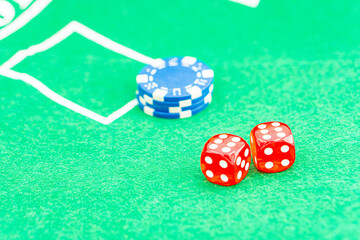 Dice with a winning combination in poker on a black table and chips in the background. Poker Chips on a gaming table