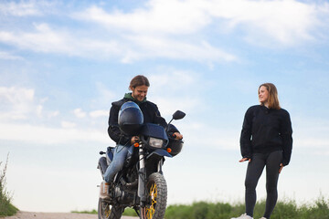 couple on a motorcycle in a field, date on a motorcycle