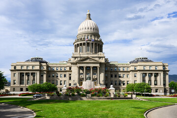 Idaho State Capitol building facade in downtown Boise with green grass lawn