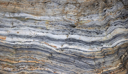  Close-up of layered rock formations with distinct horizontal lines and varied colors