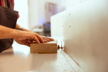 Man using edge jointer in assembly studio, performing specialized cuts, making wooden objects, close up shot. Focus on spindle moulder used by cabinetmaker for smoothing out panels