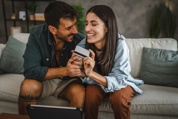 Adult caucasian couple buy online on digital tablet with credit card
