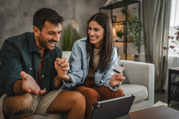 Adult caucasian couple buy online on digital tablet with credit card