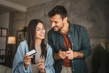 Adult caucasian couple buy online on mobile phone with credit card