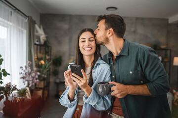 Portrait of girlfriend show mobile phone screen to her boyfriend