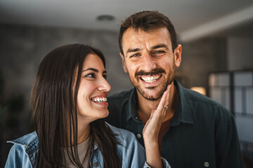 close up couple of boyfriend and girlfriend smile and hug at home