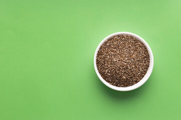 Salvia Hispanica - Organic fresh chia seeds in bowl. green color background