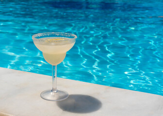 Classic margarita cocktail on the edge of the pool