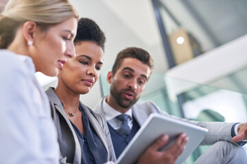 Obraz premium Business people, stairs and tablet for planning together in office, talking and support ideas. Employees, online and app for strategy or proposal in email, teamwork and diversity for collaboration