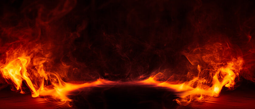 Dramatic fire and smoke effect glowing red and yellow colors exploding outwards with center space. Vivid and hot hell abstract or blazing fire background or wallpaper