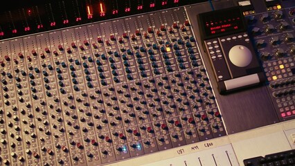 Empty professional recording studio with audio software on pc and control desk buttons or sliders. Technical equipment used to mix and master tracks, editing in post production.