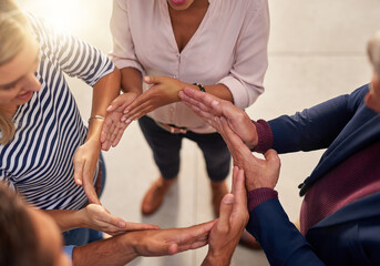 Circle, hands and huddle with team of business people in office from above for solidarity or unity. Arms, collaboration and support with employee group in workplace for synergy, trust or workflow