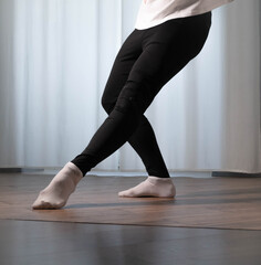 Ballet dance pose Dance poses in the studio. Male dancer warms up during training.