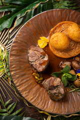 Gourmet Beef Medallions with Pastry and Fried Potato Balls on Elegant Plate