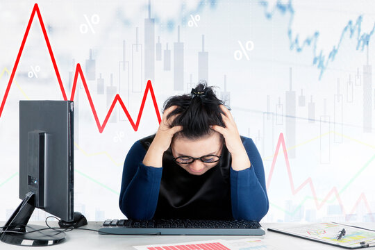 Frustrated businesswoman with personal computer and declining chart