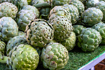 Fresh ripe green organic artichokes heads on local farmers market in Dordogne, France