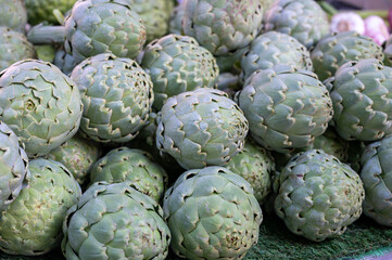 Fresh ripe green organic artichokes heads on local farmers market in Dordogne, France