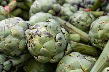 Obraz premium Fresh ripe green organic artichokes heads on local farmers market in Dordogne, France