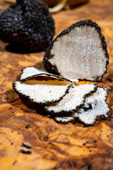 Slices of Italian black summer truffle, tasty aromatic mushroom, close up