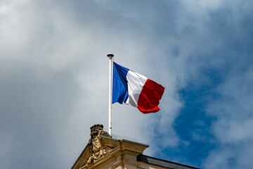 Blue red white french flag on roof of ciry hall in France