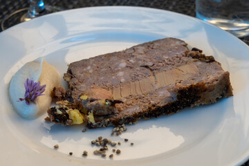 Terrine foie gras fat liver specialty food product made of liver of a duck or goose fattened by force feeding, served in French restaurant in Perigoed, Dordogne, close up