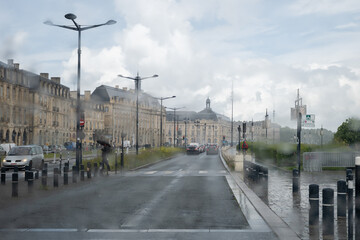 Fototapeta premium Travel destination, driving in central part of Bordeaux city, view on houses and streets in rain from car