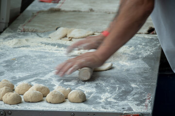 Making of flat pita bread on street market