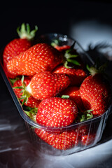 Plate with french organic red ripe sweet strawberries Fraises de Plougastel, harvested in France