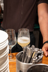 Pouring of txakoli or chacolí slightly sparkling very dry white wine produced in Spanish Basque Country in typical pinchos bar in old part of San Sebastian or Donostia, Spain