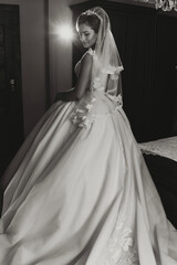 A woman in a wedding dress is standing in front of a mirror