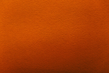 Dark red carrot paper for backgrounds, banners and web elements. Smooth textured wallpaper.