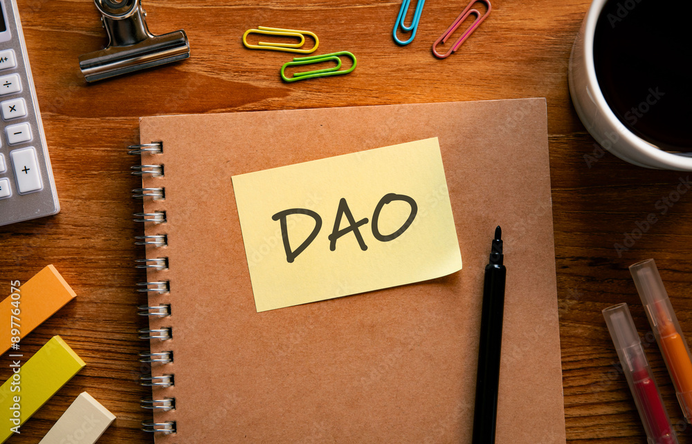 Poster there is sticky note with the word dao. it is an abbreviation for decentralized autonomous organizat