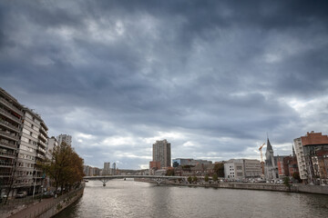 Naklejka premium Panorama of the city center of Liege, Belgium, during a cloudy afternoon of autumn, in centre ville, with the meuse river (maas) in front. Liege is one of the biggest cities of Belgium and Wallonia.