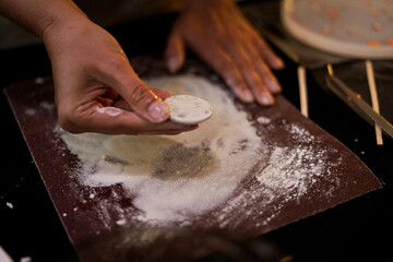 Grinding polymer plaster form with sandpaper during handmade workshop. Close up. 