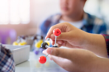 Students are studying simulate shape of covalent molecules by connecting molecular function shapes...