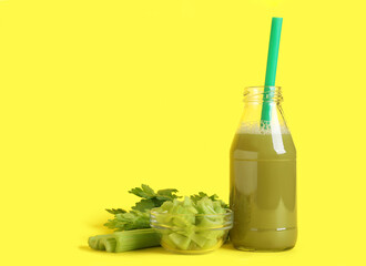 Bottle of celery juice on yellow background