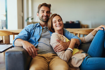 Fototapeta premium Portrait, home and couple with happiness, hug and break with romance, relax and relationship. Face, apartment and man with woman, marriage and commitment with embrace, time together or love in lounge
