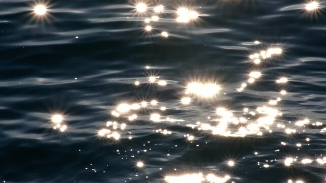 Beautiful sparkling sunset reflections on dark blue water surface. Continuously changing wavy sea surface for background. Neutral mirror effect, sun glittering around. Summer, enjoying water.